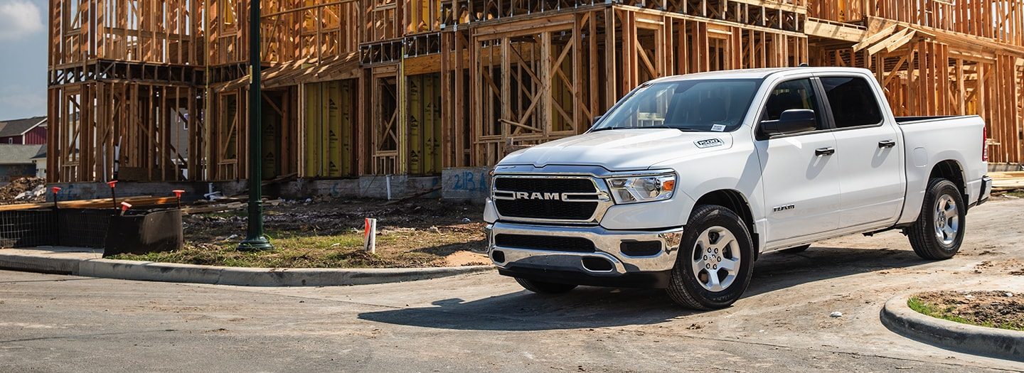The 2020 Ram 1500 Tradesman is parked at a construction site.