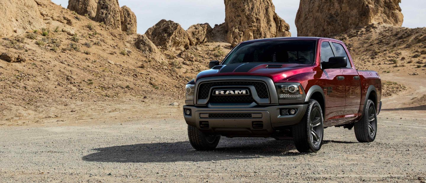 The 2022 Ram 1500 Classic parked on a twisting desert road with rocky outcroppings in the distance.
