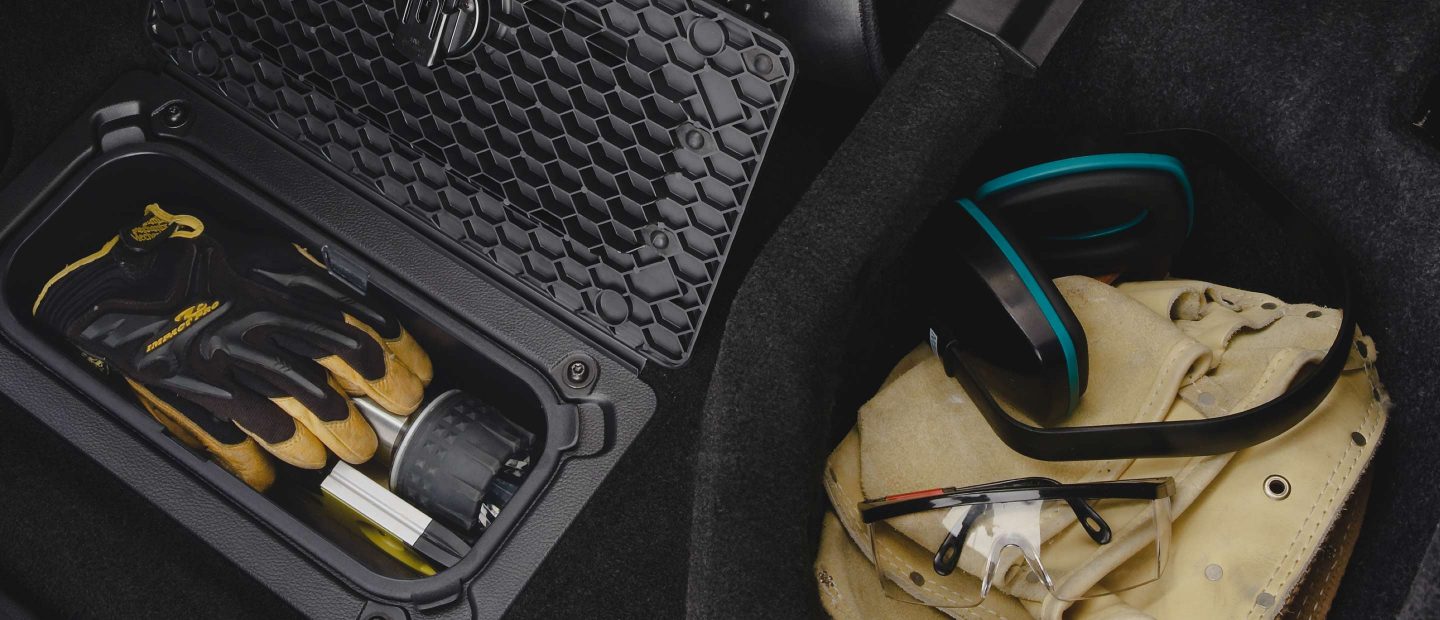 The Ram Bin in the 2022 Ram 1500 Classic, containing a pair of work gloves and a flashlight.